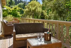 Wicker furniture on large deck with views of treespenthouse-balcony.jpg
